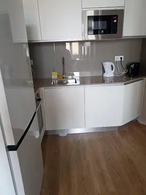 a white kitchen with a sink and a microwave at Gaia Loves You - Ponte D. Luis in Vila Nova de Gaia
