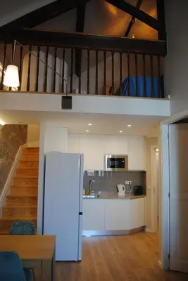 a kitchen and a living room with a loft at Gaia Loves You - Ponte D. Luis in Vila Nova de Gaia