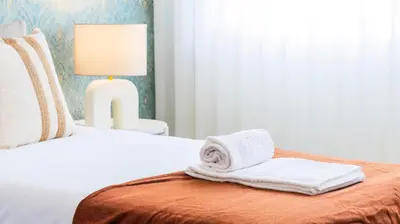 a hotel room with a bed with a towel on it at Urban Retreat Porto by LovelyStay in Porto