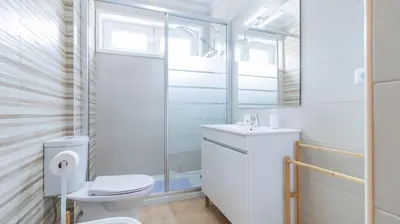a white bathroom with a toilet and a sink at Urban Retreat Porto by LovelyStay in Porto