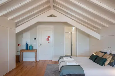a bedroom with white ceilings and a large bed at Nautical Luxury Loft in Porto