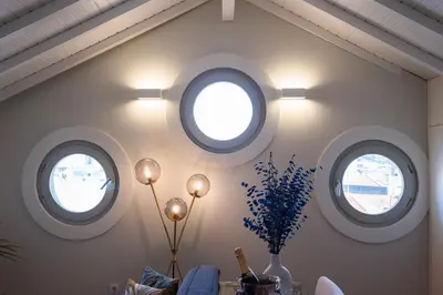 a room with three circular windows in the wall at Nautical Luxury Loft in Porto