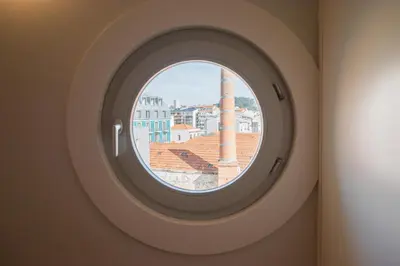 a round window with a view of the city at Nautical Luxury Loft in Porto