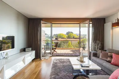 a living room with a couch and a table at GuestReady - Freixo lux with Douro River view in Porto
