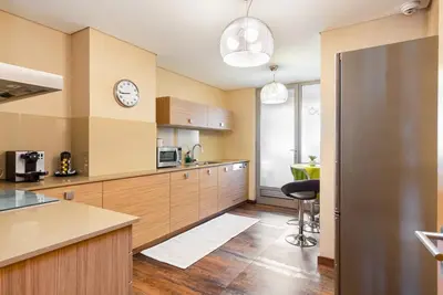 a kitchen with a counter and a clock on the wall at GuestReady - Freixo lux with Douro River view in Porto