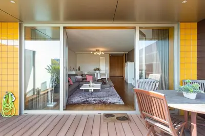 a living room with a large sliding glass door at GuestReady - Freixo lux with Douro River view in Porto