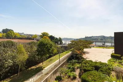 a view of a garden from the roof of a building at GuestReady - Freixo lux with Douro River view in Porto