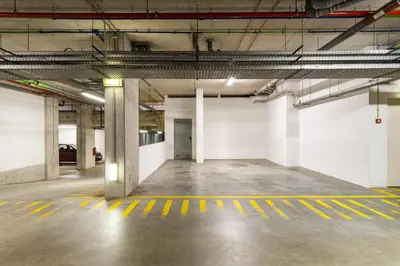 an empty parking lot in a parking garage at GuestReady - Freixo lux with Douro River view in Porto