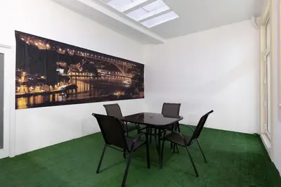 a dining room with a table and chairs and a painting at OPO Santa Catarina in Porto