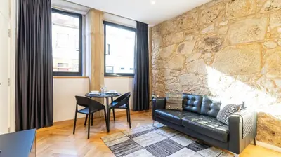 a living room with a leather couch and a table at Premium Duplex in Bonfim by LovelyStay in Porto