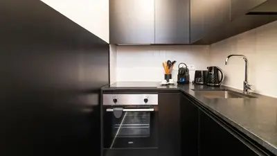 a kitchen with a sink and a dishwasher at Premium Duplex in Bonfim by LovelyStay in Porto