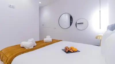 a white room with a bed with a tray of food at Luxury Oasis in Bonfim by LovelyStay in Porto