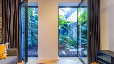 a room with a large glass door with a fish tank at Luxury Oasis in Bonfim by LovelyStay in Porto