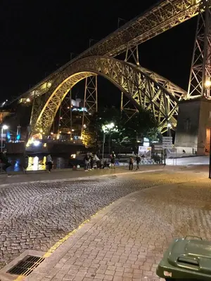 a bridge at night with people walking on the street at Porto Chique AL 2 in Porto