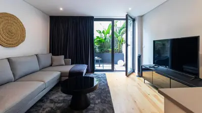 a living room with a couch and a flat screen tv at Premium 2BR Flat near Santa Catarina by LovelyStay in Porto