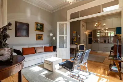 a living room with a couch and a table and chairs at Victoria House in Porto