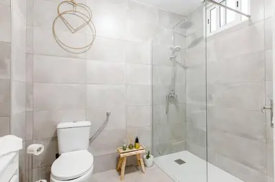a bathroom with a toilet and a glass shower at River Fleat 0 - Heart of Porto in Porto