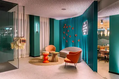 a living room with green walls and chairs and a table at Vincci Bonjardim in Porto