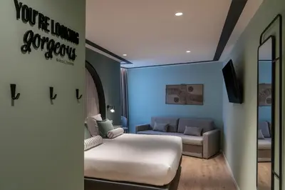 a hotel room with a bed and a couch at Vincci Bonjardim in Porto