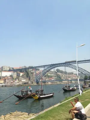 two boats in a river with a bridge in the background at Porto Chique AL 3 in Porto