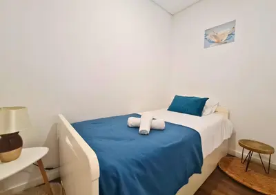 a room with a bed with two towels on it at Alegria Stay in Porto