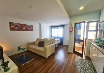 a living room with a couch and a table at Alegria Stay in Porto