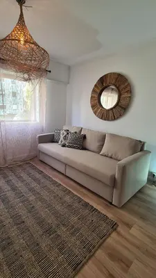 a living room with a couch and a mirror at Enjoy Porto's Vibes in Porto