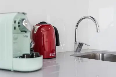 a kitchen counter with a toaster and a sink at Cozy Studio-Fast Wi-Fi-Near Campanhã Station & River in Porto