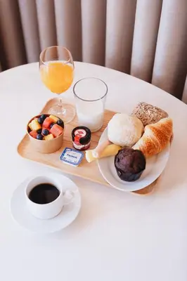 a tray of breakfast foods and a glass of orange juice at ORM Padrão Apartment in Porto