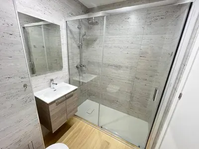a bathroom with a glass shower and a sink at HEART OF THE CITY 10 ! in Porto