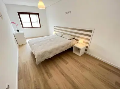 a bedroom with a large bed and a wooden floor at HEART OF THE CITY 10 ! in Porto