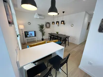 a living room with a white table and chairs at HEART OF THE CITY 10 ! in Porto