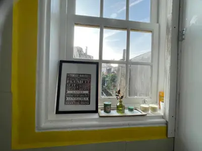 a window with a picture and a frame in a room at Owls Hostel Ildefonso in Porto