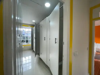 a hallway with white lockers in a house at Owls Hostel Ildefonso in Porto