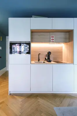 a kitchen with white cabinets and a sink at HM - Infante Riverside Apartment B in Porto