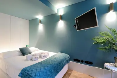 a bedroom with a bed and a flat screen tv at HM - Infante Riverside Apartment B in Porto