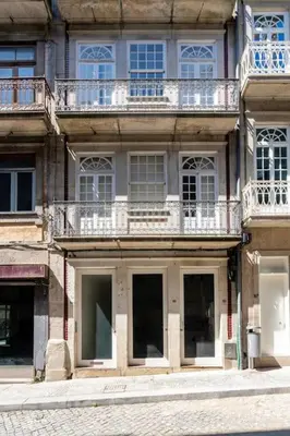a building with windows and balconies on a street at VIVA Aliados Downtown in Porto