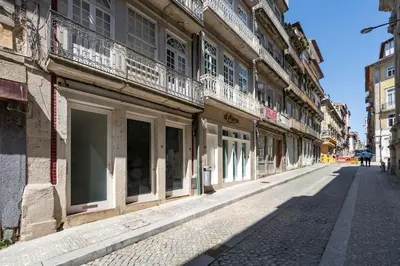 an empty street in a city with buildings at VIVA Aliados Downtown in Porto
