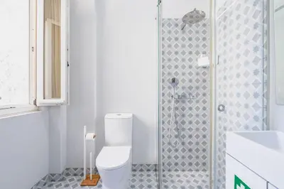 a bathroom with a toilet and a shower at VIVA Arts Cozy Studio in Porto
