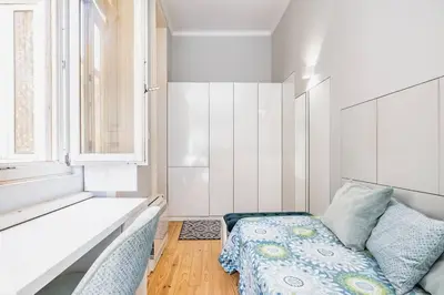 a small bedroom with a bed and a window at VIVA Arts Cozy Studio in Porto