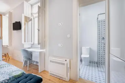 a bedroom with a shower and a bed and a desk at VIVA Arts Cozy Studio in Porto