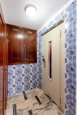 a bathroom with blue and white tiles on the walls at VIVA Nanda's Place in Porto