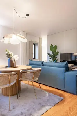 a living room with a blue couch and a table at VIVA Formosa Flat in Porto