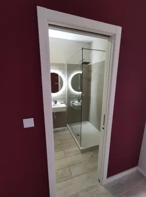 a bathroom with a shower and a glass door at Leote House - Studio 1 in Porto