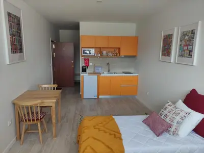 a room with a bed and a table and a kitchen at Leote House - Studio 1 in Porto