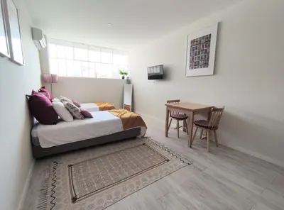 a bedroom with a bed and a table at Leote House - Studio 1 in Porto