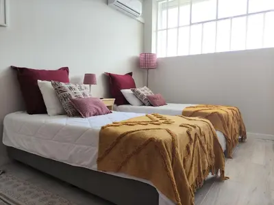 two beds with blankets and pillows in a bedroom at Leote House - Studio 1 in Porto