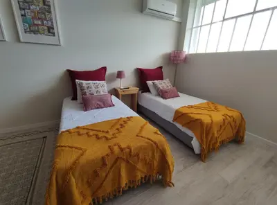 a bedroom with two beds and a window at Leote House - Studio 1 in Porto