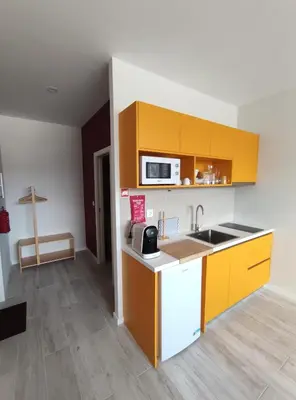 a kitchen with yellow cabinets and a sink at Leote House - Studio 1 in Porto