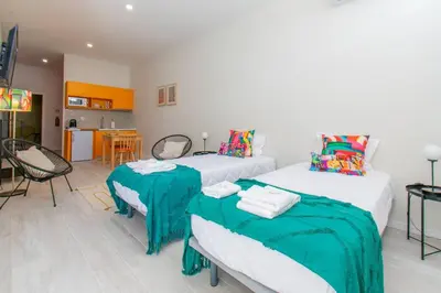 a room with two beds and a kitchen at Leote House - Studio 3 in Porto